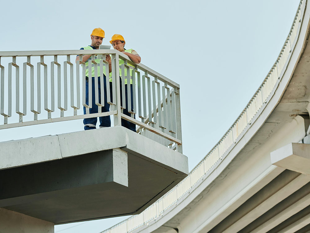 engineers examining road structure
